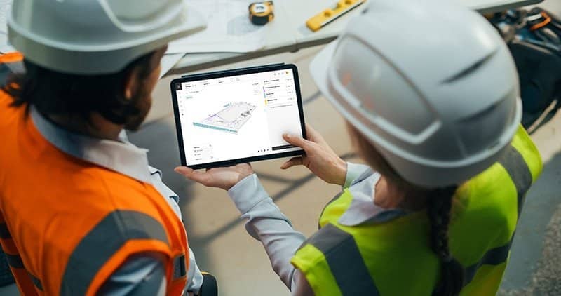 A site meeting showing team members reviewing the BIM